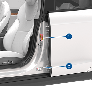Two labels on the driver's center door pillar indicating how much weight the vehicle can carry