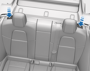 Two arrows each pointing to a button on the outside of the rear seats