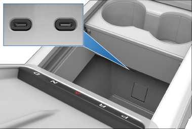 Front console with front compartment open, revealing two USB ports on rear wall of compartment