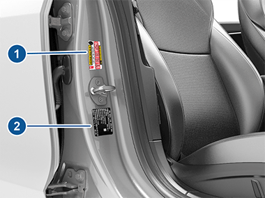 Two labels on center door pillar indicating how much weight the vehicle can carry