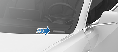 Arrow pointing to the VIN plate on top of the dashboard.