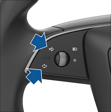 Closeup of left and right turn signals on steering yoke.